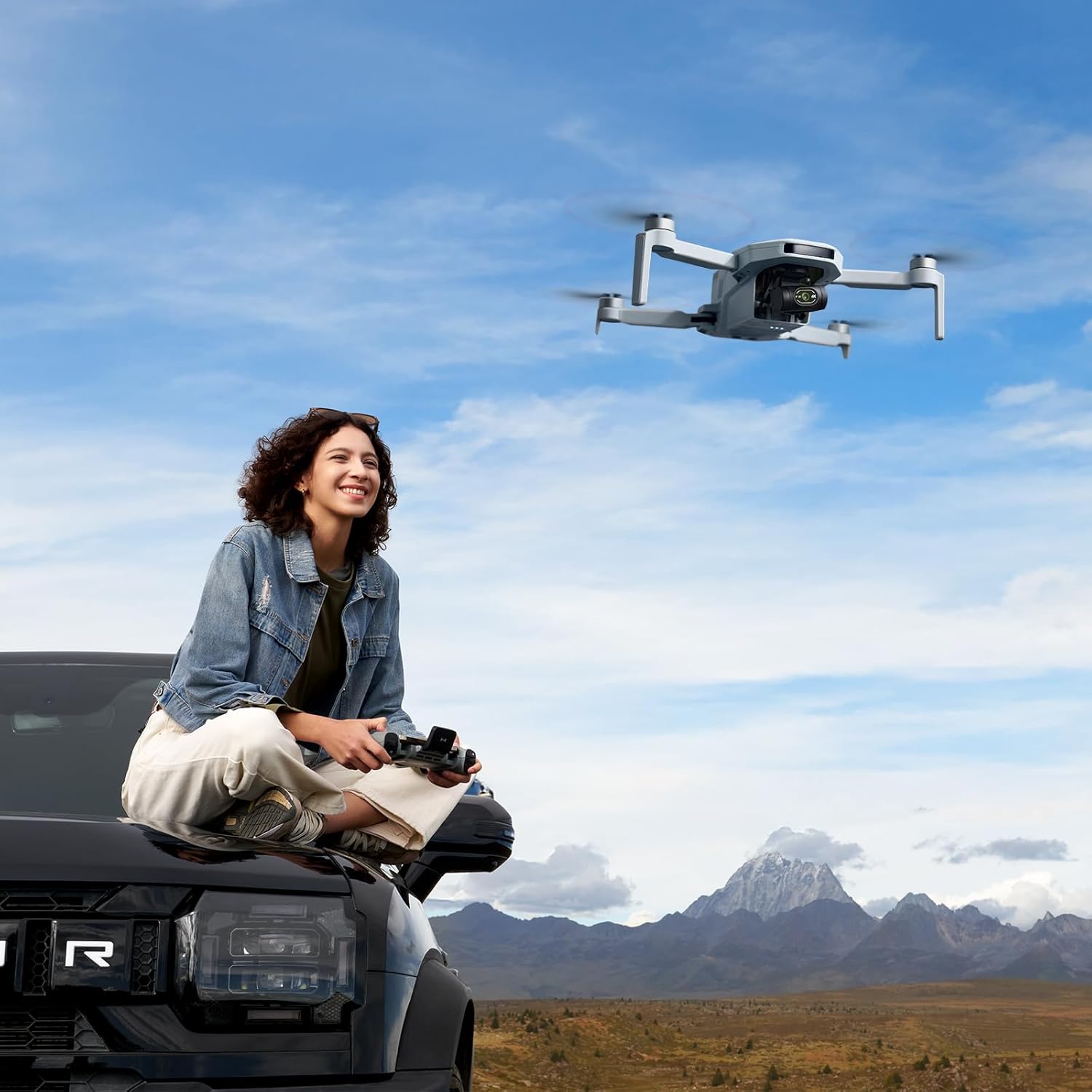 Woman using the Potensic ATOM 2 drone outdoors with the carry bag