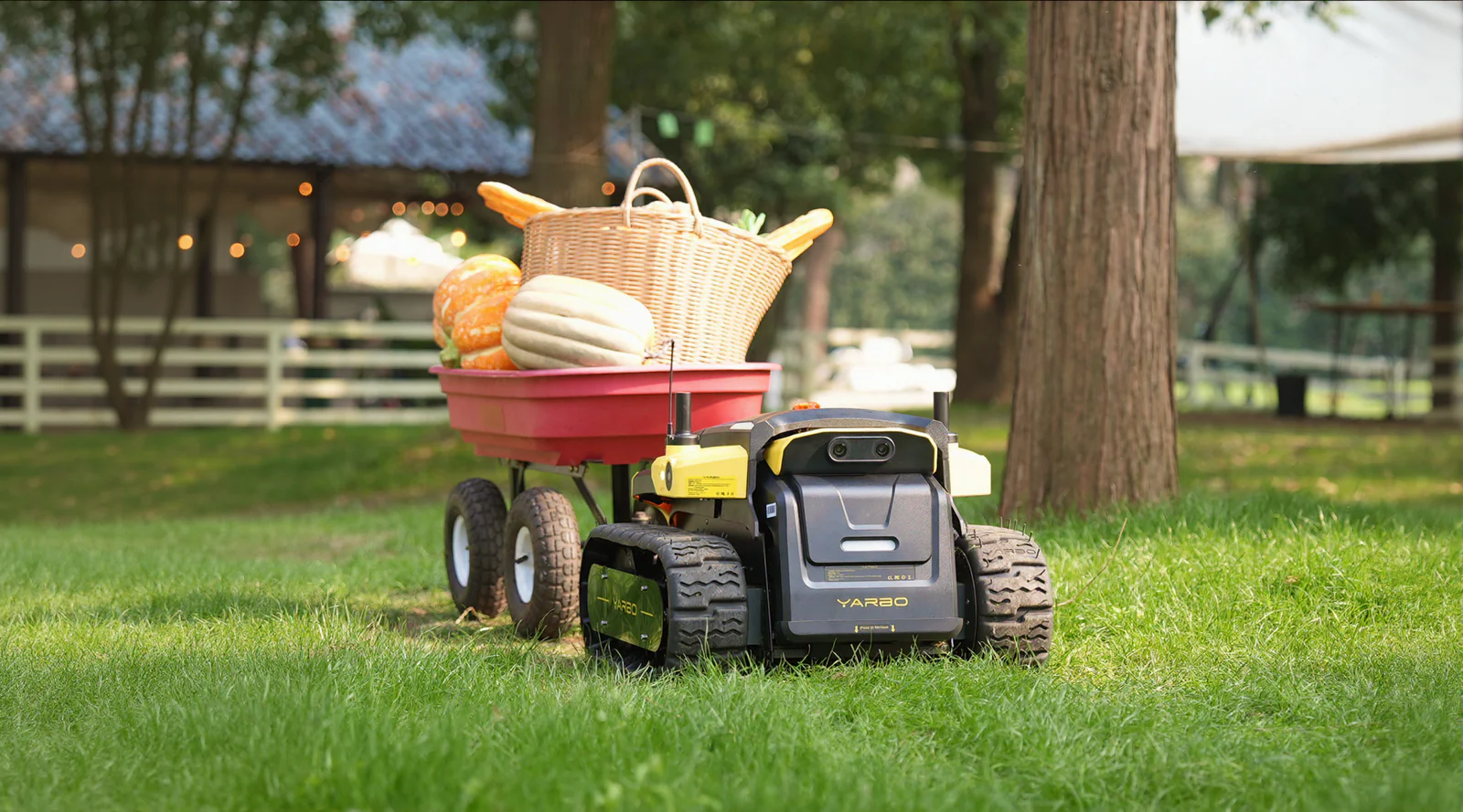 Yarbo Core towing a utility cart during outdoor yard work