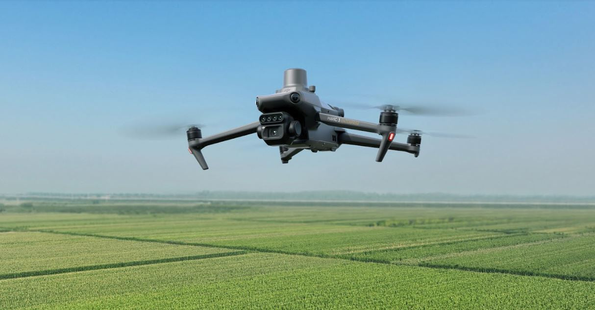 DJI Mavic 3M Multispectral drone flying above an agricultural field